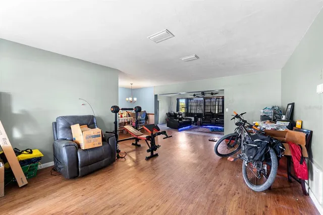 a view of a room with furniture and wooden floor