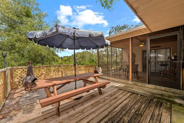 a view of sitting area with furniture and umbrella