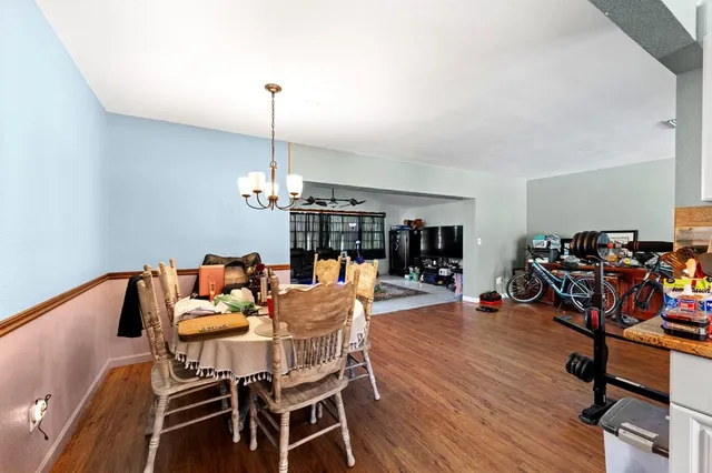 a view of a dining room with furniture wooden floor and chandelier