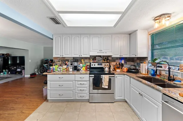 a kitchen with cabinets and appliances