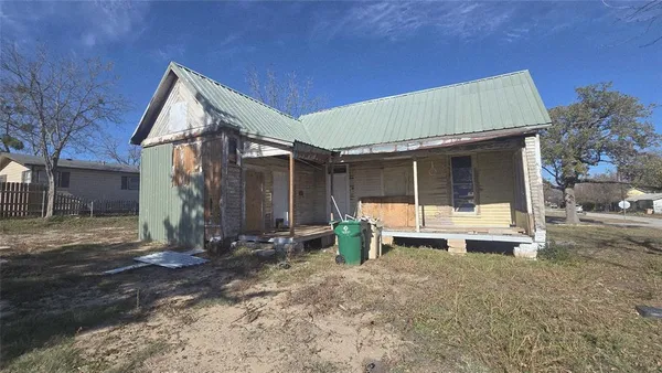 a view of backyard with a small cabin and a chair