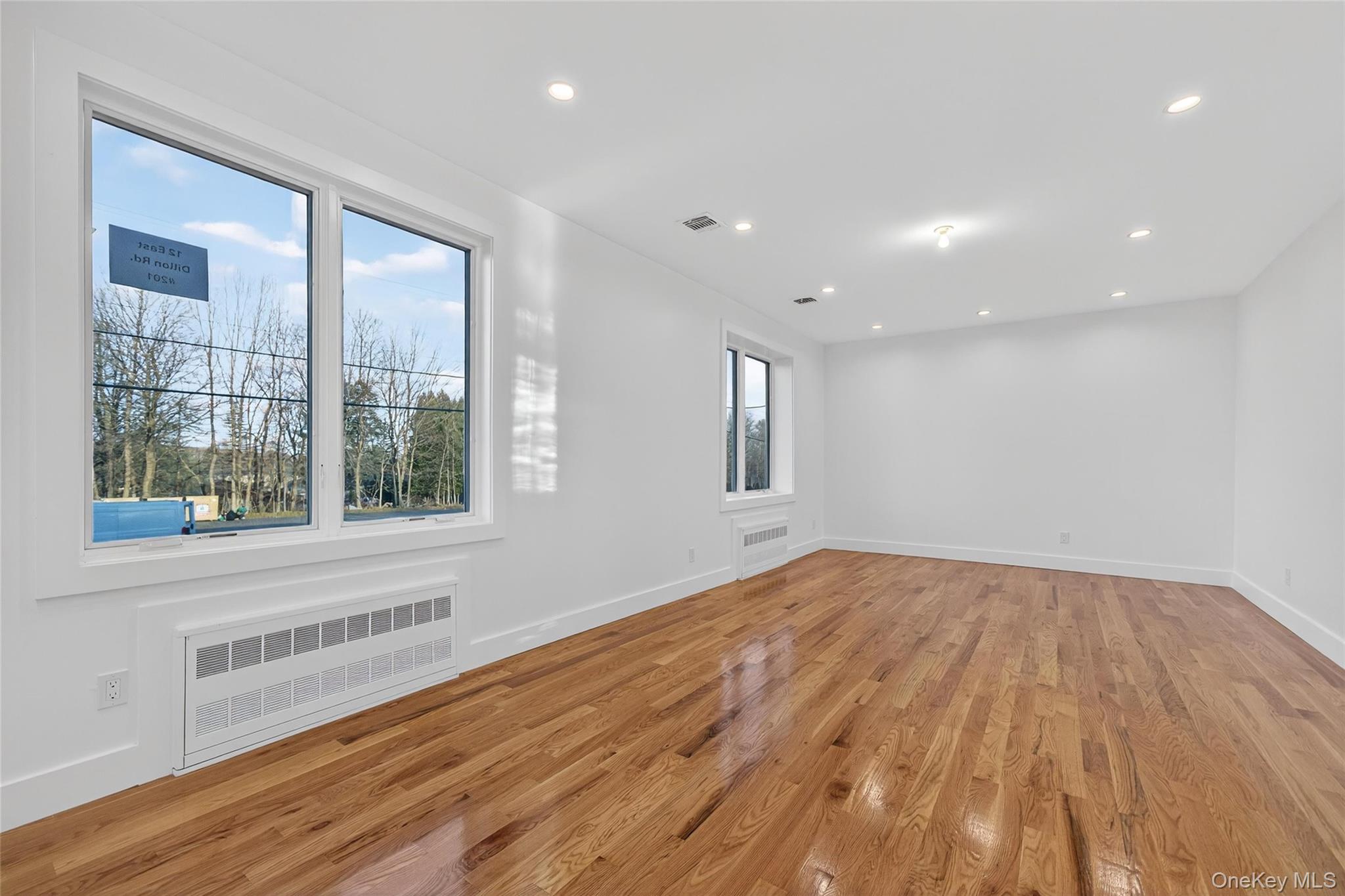 12 East Dillon Road Monticello, NY 12701 - Photo 11 of 47 a view of an empty room with wooden floor and a window