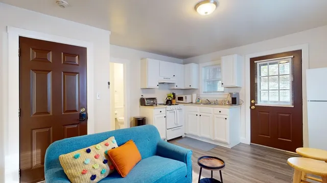 a kitchen with furniture a refrigerator and a stove top oven