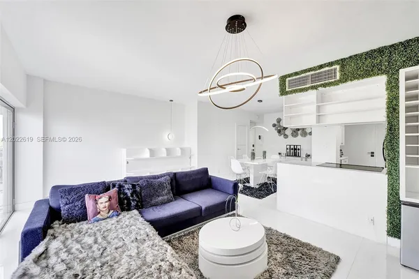 a living room with furniture a rug and white walls