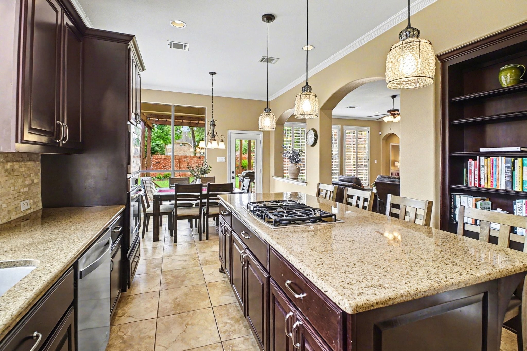 8210 Thunder Ridge Way Missouri City, TX 77459 - Photo 41 of 42 Experience seamless living featuring an open floor plan with beautiful arches leading to the breakfast area and inviting backyard patio.