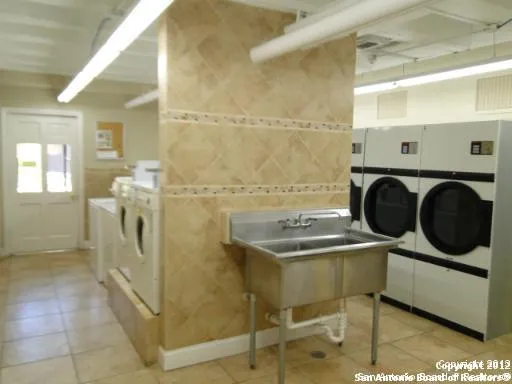a view of a swimming pool with a patio and plants