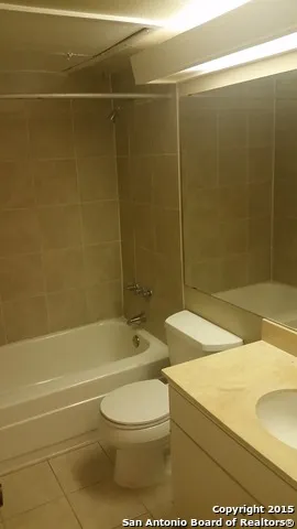 a bathroom with a toilet a sink and shower