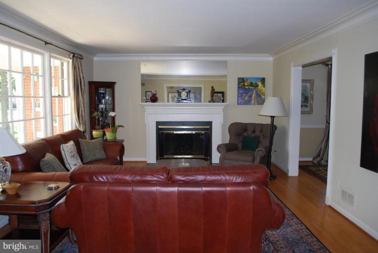 6105 Overlea Road Bethesda, MD 20816 - Photo 2 of 18 a living room with furniture and a fireplace