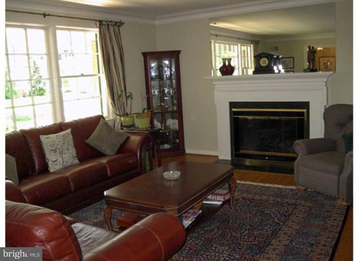6105 Overlea Road Bethesda, MD 20816 - Photo 15 of 18 a living room with furniture a window and a fireplace