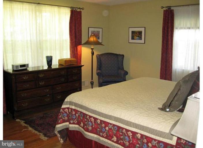 6105 Overlea Road Bethesda, MD 20816 - Photo 16 of 18 a bed sitting in a bedroom next to a window