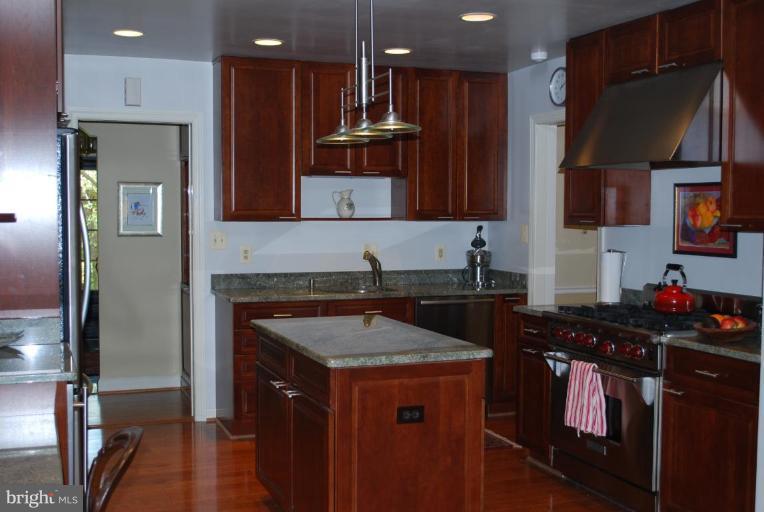 6105 Overlea Road Bethesda, MD 20816 - Photo 4 of 18 a kitchen with a stove a sink and a refrigerator