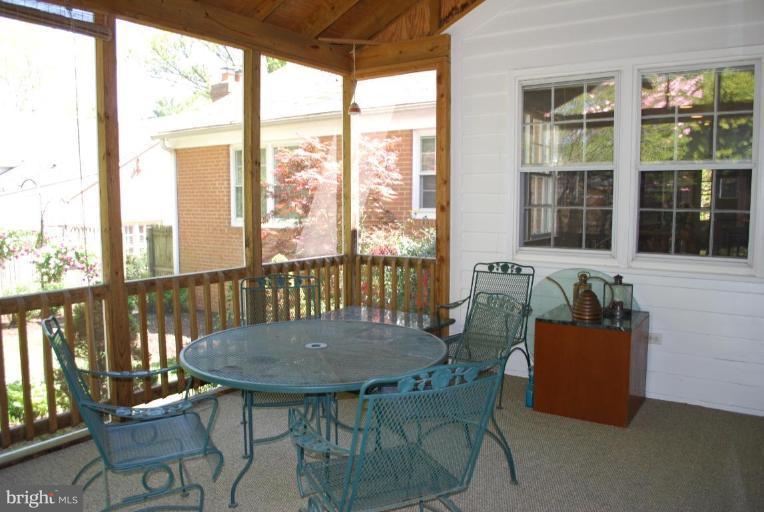 6105 Overlea Road Bethesda, MD 20816 - Photo 6 of 18 a view of a room with a table and chairs