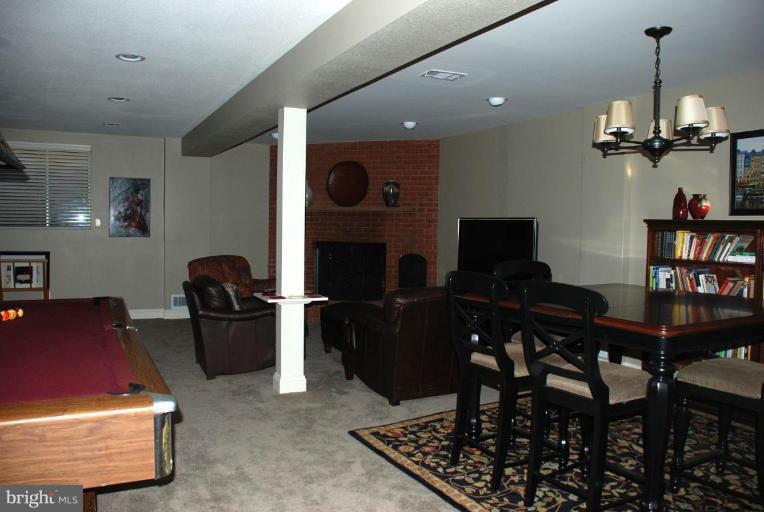 6105 Overlea Road Bethesda, MD 20816 - Photo 7 of 18 a living room with furniture a piano and a flat screen tv