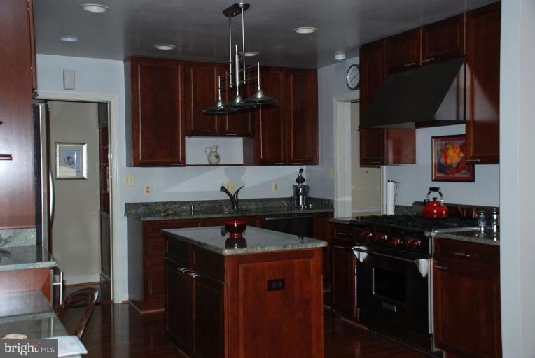 6105 Overlea Road Bethesda, MD 20816 - Photo 8 of 18 a kitchen with a sink a stove and refrigerator