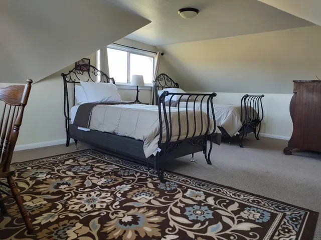 a bed room with a bed and a chair