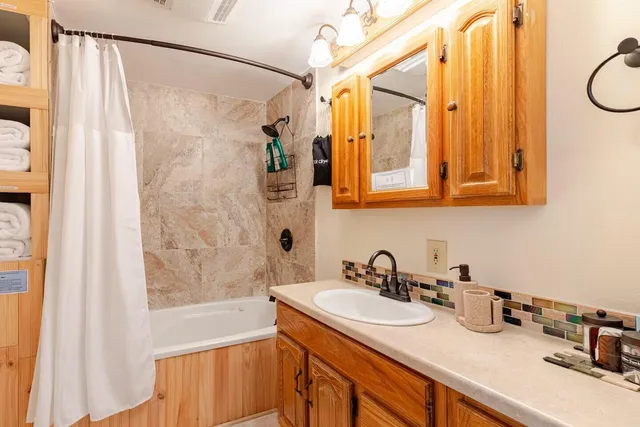 a bathroom with a sink and a shower curtain