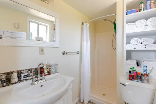 a bedroom with a bed and a book shelf