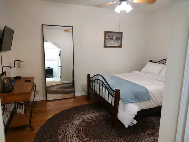 a bedroom with a bed and window