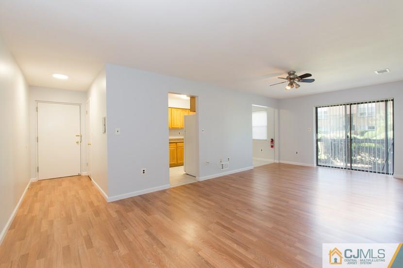 1504 Raspberry Court, Unit 1504 Edison, NJ 08817 - Photo 3 of 17 wooden floor in an empty room with a window