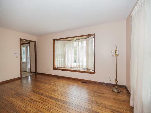 11N728 Old Barn Road Elgin, IL 60124 - Photo 4 of 25 a view of an empty room with wooden floor and a window