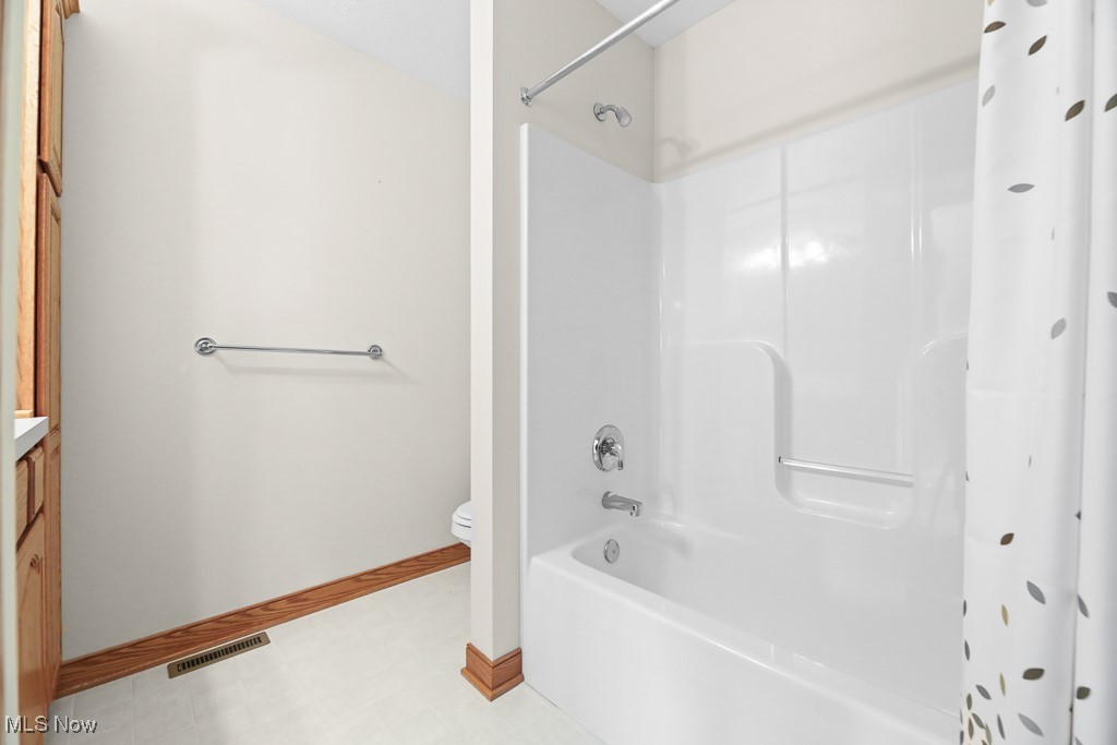 4808 Sherman Road Kent, OH 44240 - Photo 29 of 50 Bathroom featuring shower / bathtub combination with curtain, vanity, and light floors