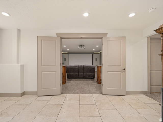 1279 West 1500th Street North Mapleton, UT 84664 - Photo 56 of 83 Tiled entryway opening to a dedicated home theater space with a large projection screen and recessed lighting