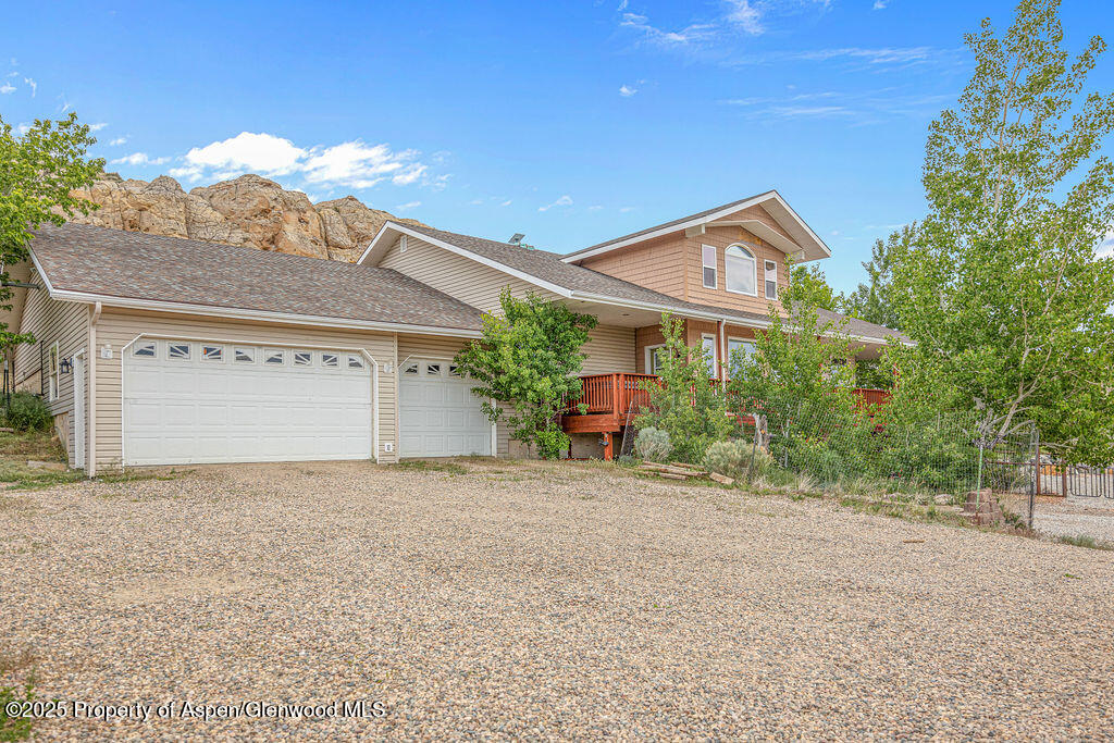 289 Lewis Lane Craig, CO 81625 - Photo 23 of 104 a front view of a house with a yard and garage