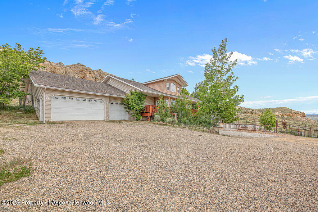 289 Lewis Lane Craig, CO 81625 - Photo 92 of 104 a front view of a house with a yard and garage