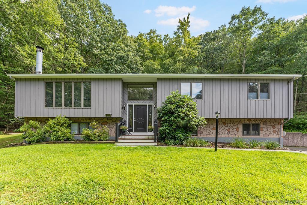 150 Seymour Road Woodbridge, CT 06525 - Photo 1 of 1 a front view of house with yard and trees