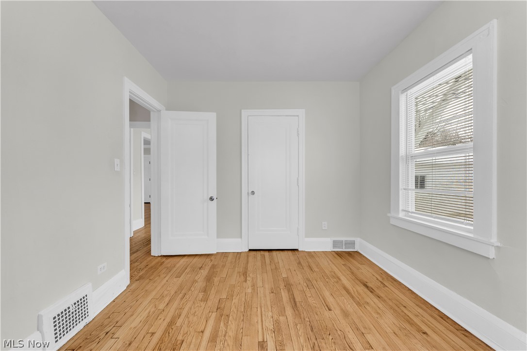 3318 Milverton Road, Unit 1/DN Shaker Heights, OH 44120 - Photo 15 of 21 This room features hardwood floors, light-colored walls, and a window with blinds