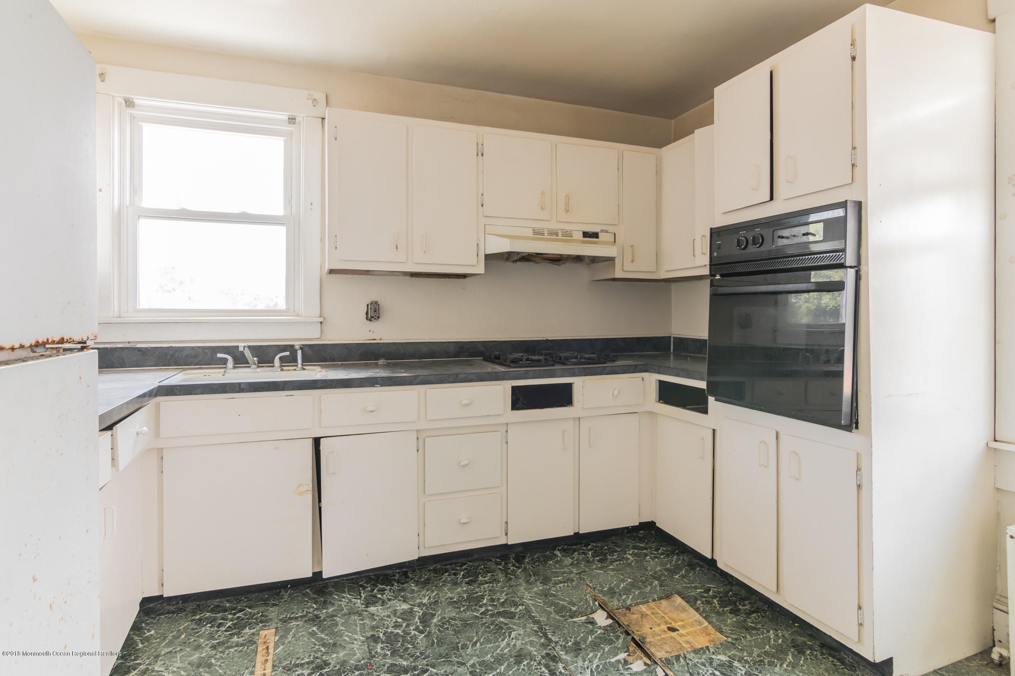 1723 River Road Belmar, NJ 07719 - Photo 11 of 29 a kitchen with granite countertop white cabinets and white appliances