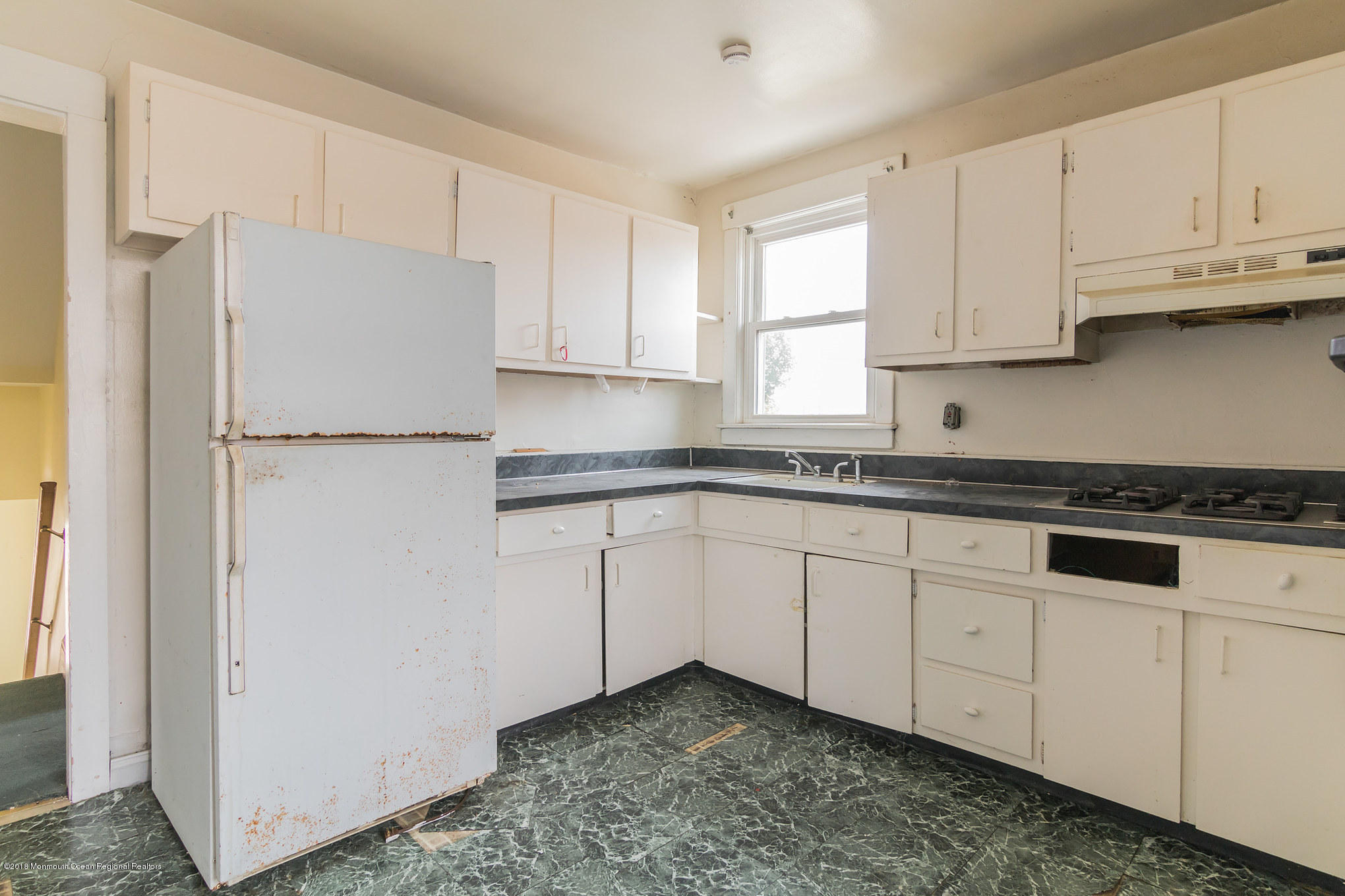 1723 River Road Belmar, NJ 07719 - Photo 12 of 29 a kitchen with granite countertop white cabinets and refrigerator