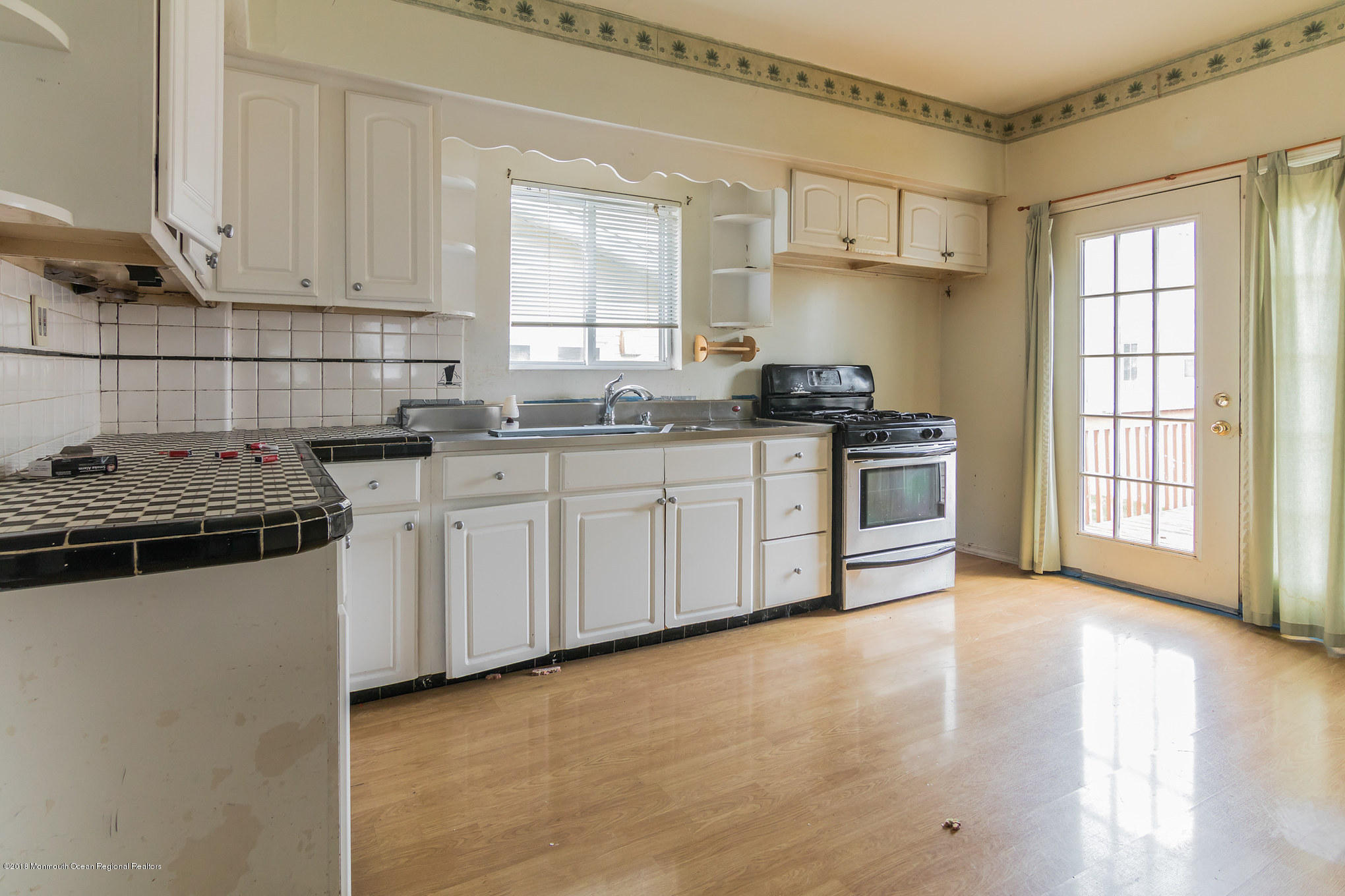 1723 River Road Belmar, NJ 07719 - Photo 13 of 29 a kitchen with stainless steel appliances a stove a sink and white cabinets