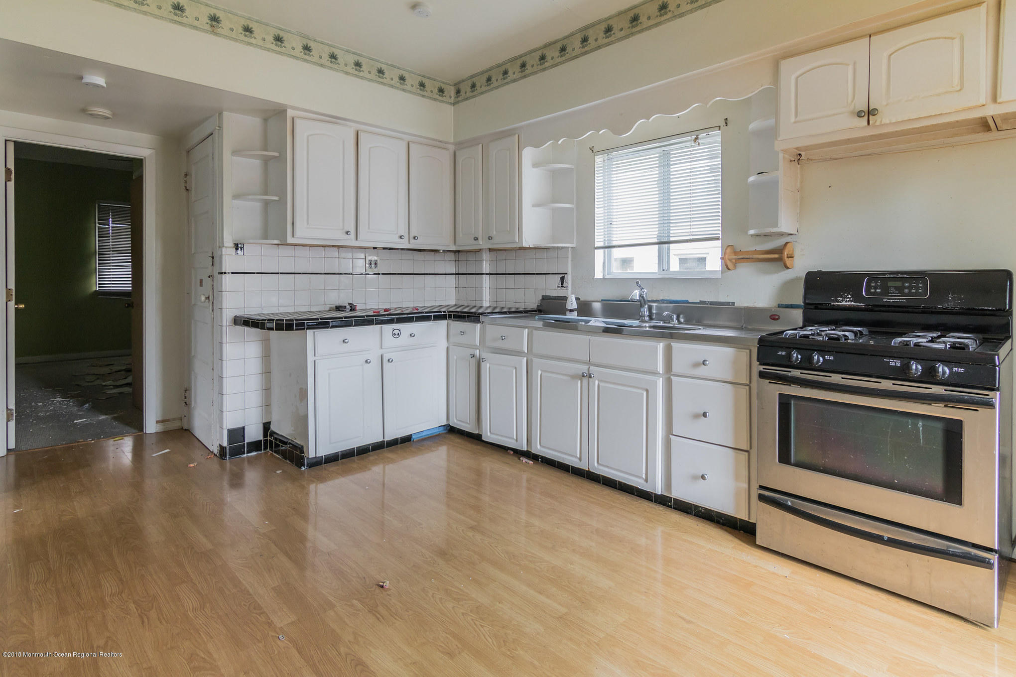1723 River Road Belmar, NJ 07719 - Photo 14 of 29 a kitchen with stainless steel appliances granite countertop a stove a sink and white cabinets