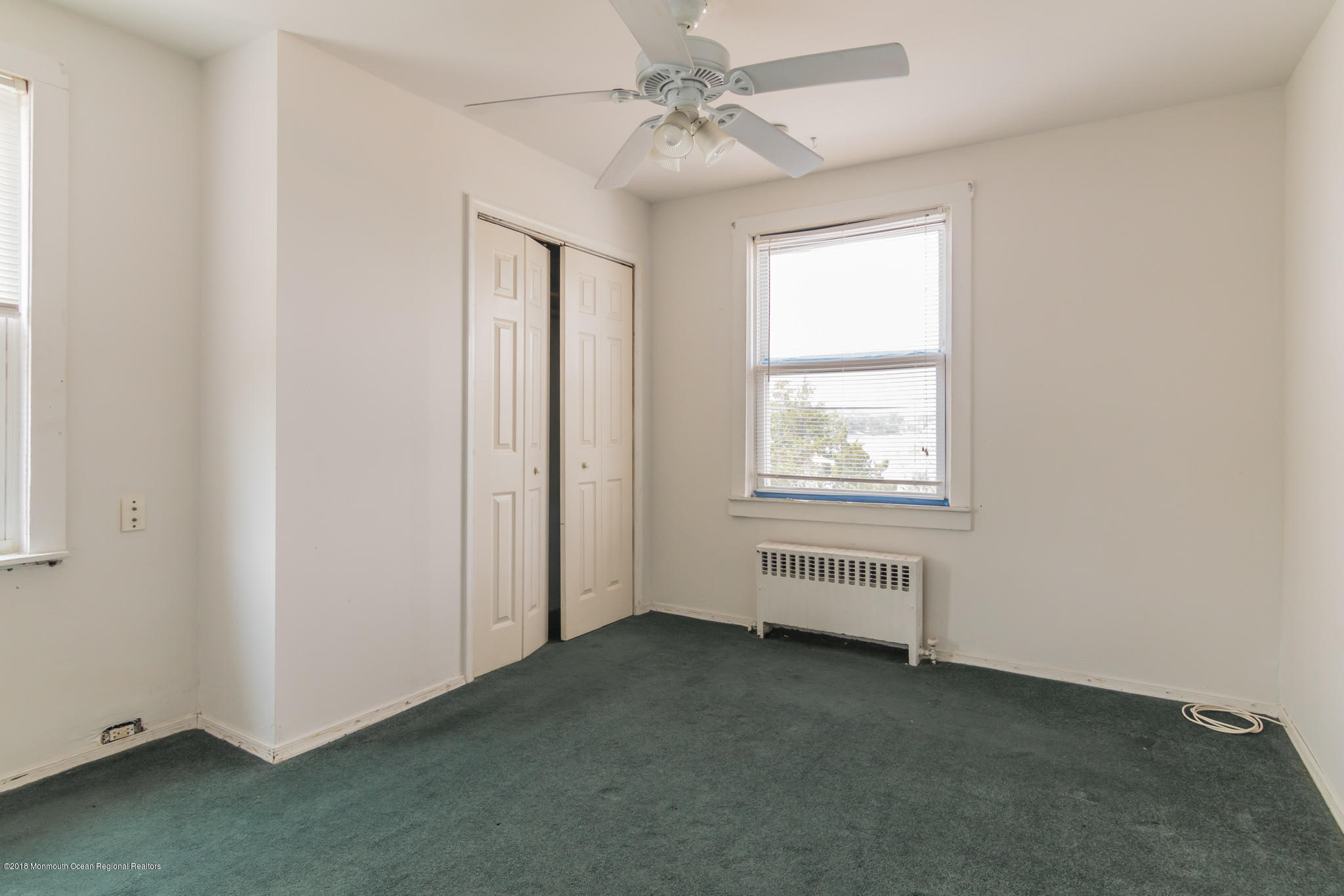 1723 River Road Belmar, NJ 07719 - Photo 20 of 29 an empty room with windows and fan