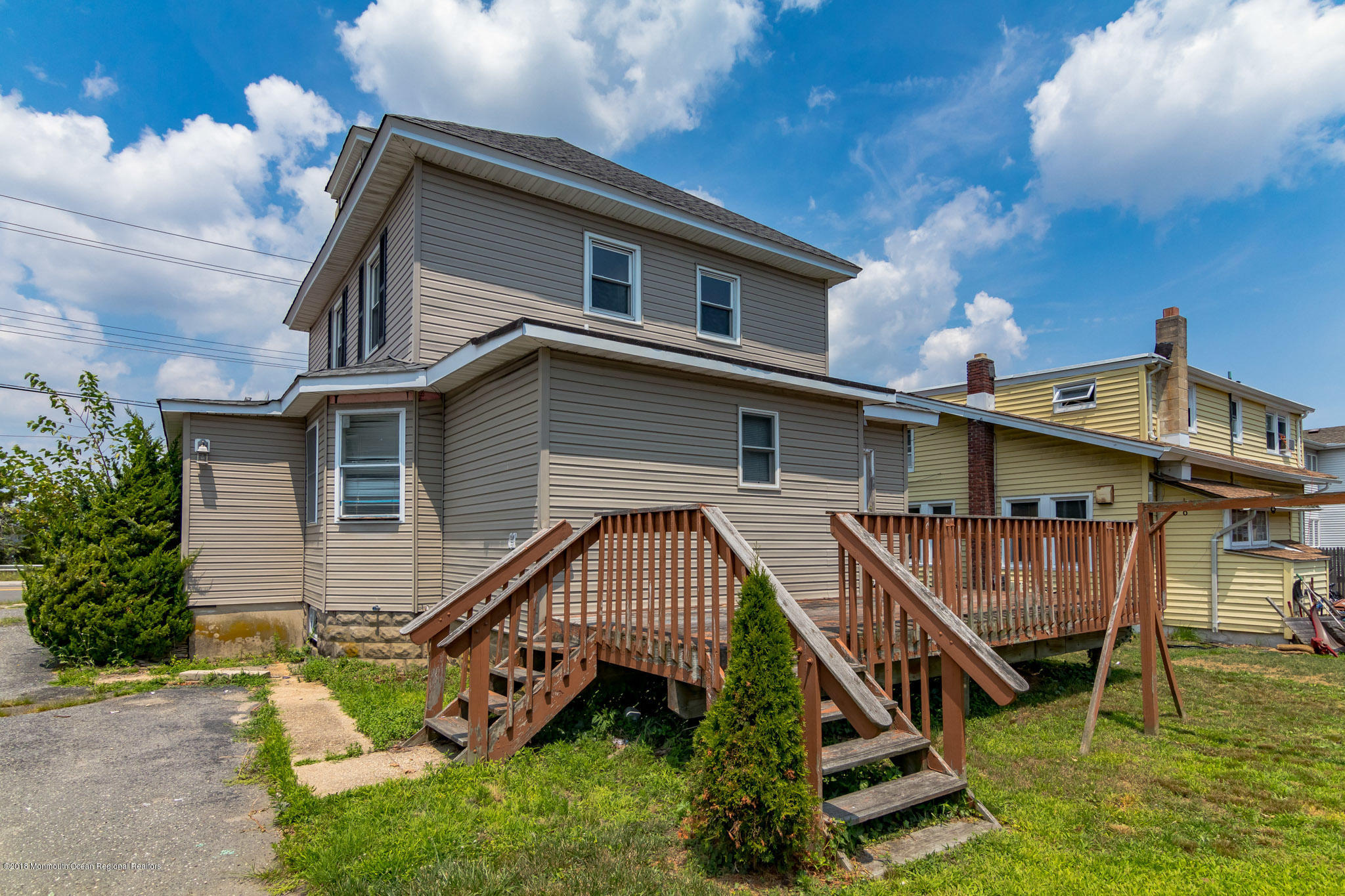 1723 River Road Belmar, NJ 07719 - Photo 4 of 29 a view of a house with a wooden deck and a yard