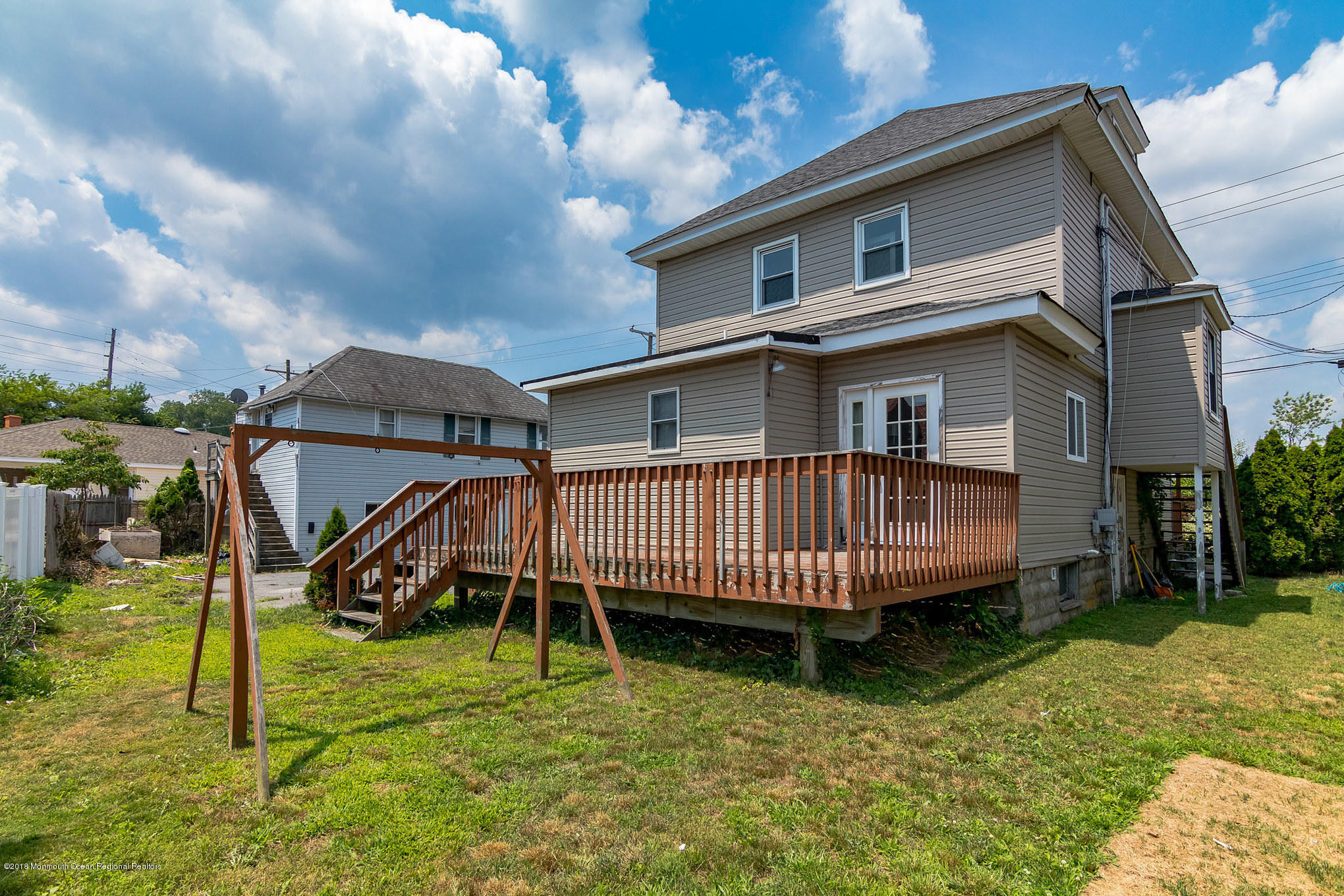 1723 River Road Belmar, NJ 07719 - Photo 5 of 29 a small house with a white roof and wooden fence