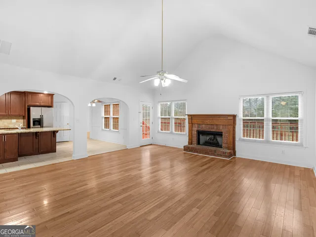 a view of a room with wooden floor