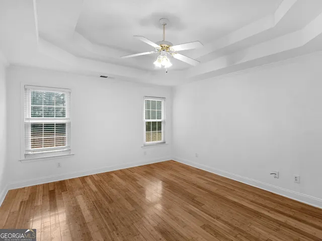 a white bath tub sitting next to a shower