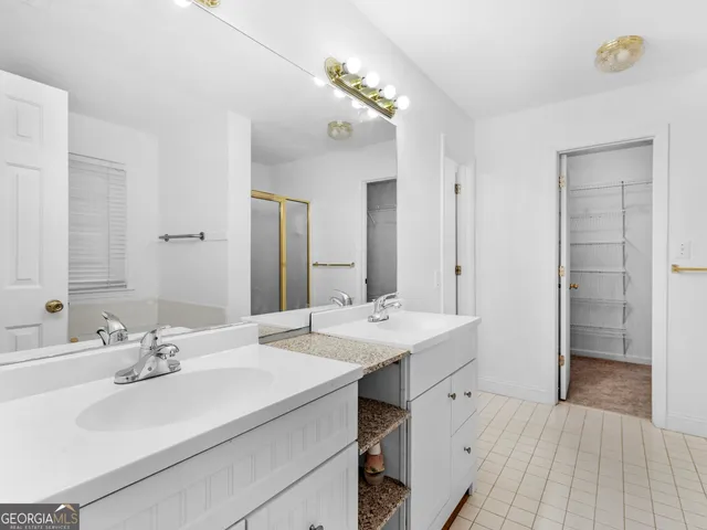 a bathroom with a sink double vanity and a mirror