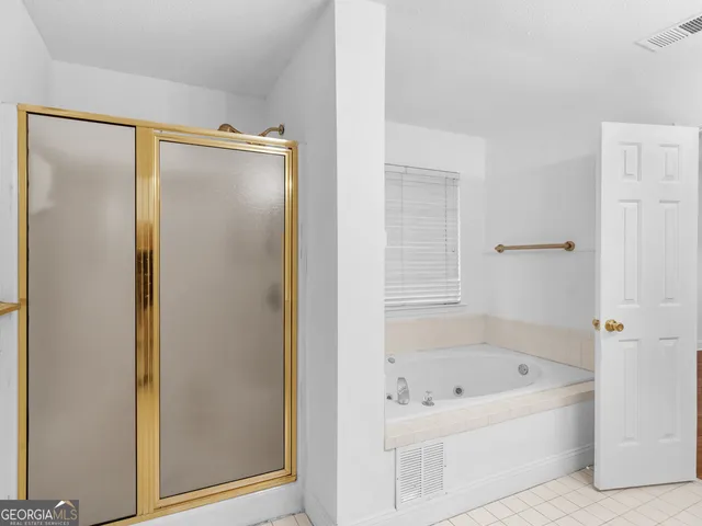 a view of a room with wooden floor and a ceiling fan