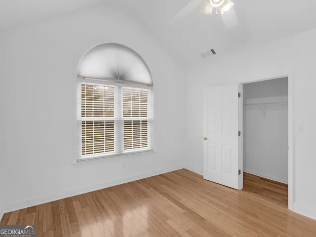 a view of a room with wooden floor and white walls