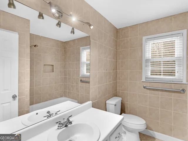 a kitchen with granite countertop white cabinets and sink