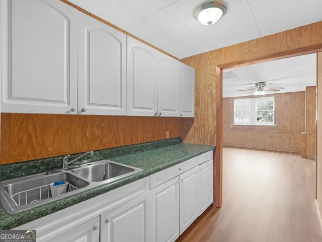 a bathroom with a sink a toilet a mirror and shower