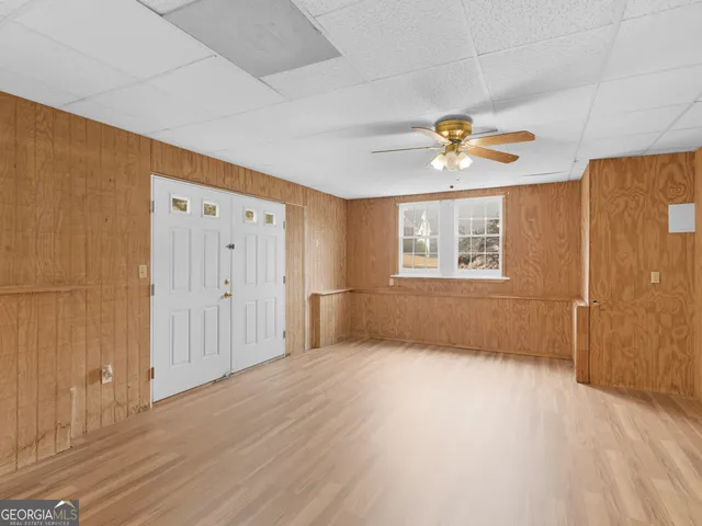 a view of an empty room with a fireplace and a window