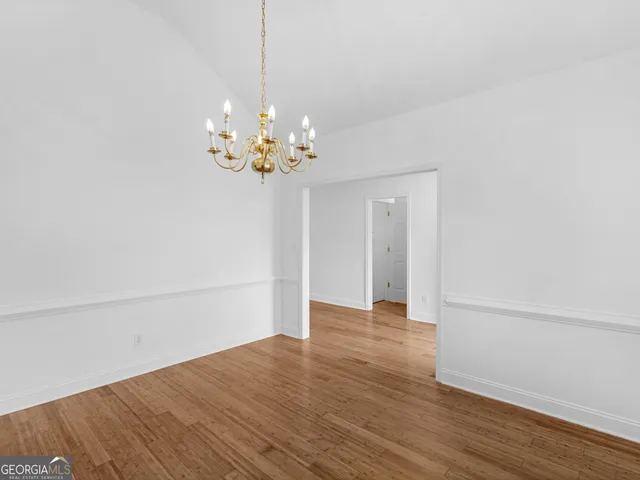 a view of a room with wooden floor fireplace and a window