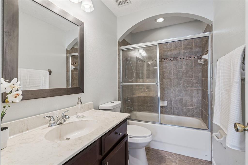 16178 Old Ash Loop Orlando, FL 32828 - Photo 12 of 24 a bathroom with a sink toilet and shower