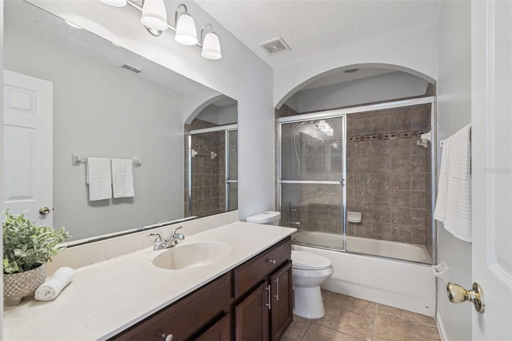16178 Old Ash Loop Orlando, FL 32828 - Photo 17 of 24 a bathroom with a double vanity sink toilet and shower