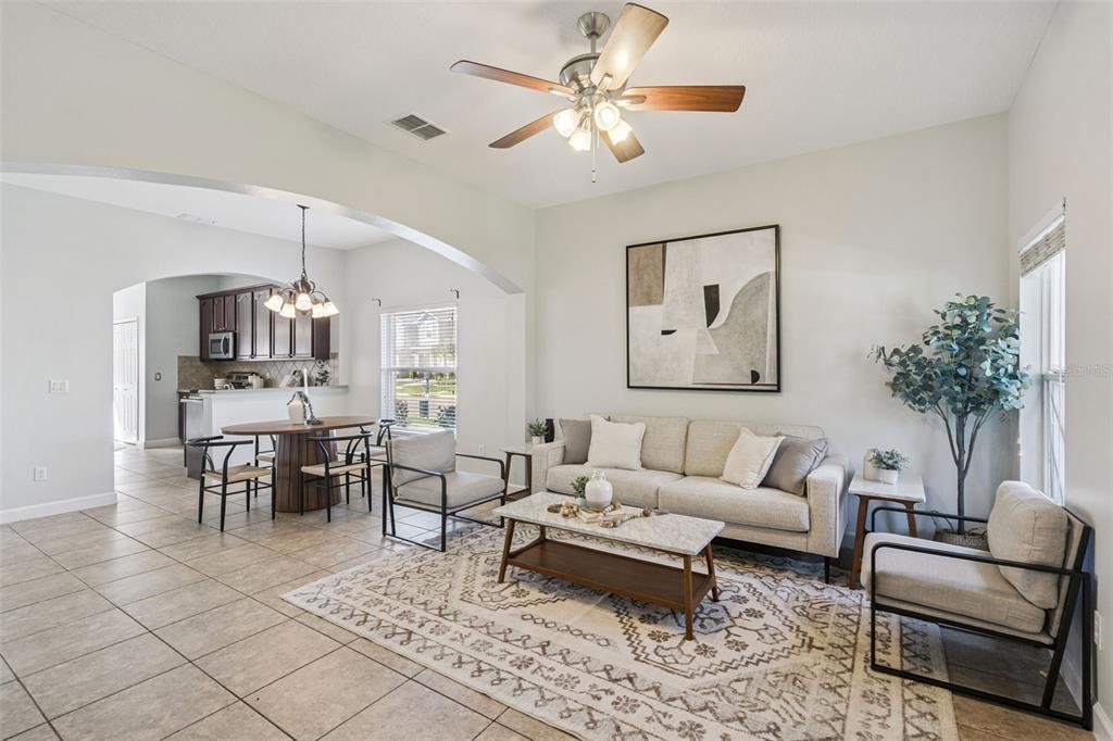 16178 Old Ash Loop Orlando, FL 32828 - Photo 3 of 24 a living room with furniture a chandelier and a dining table