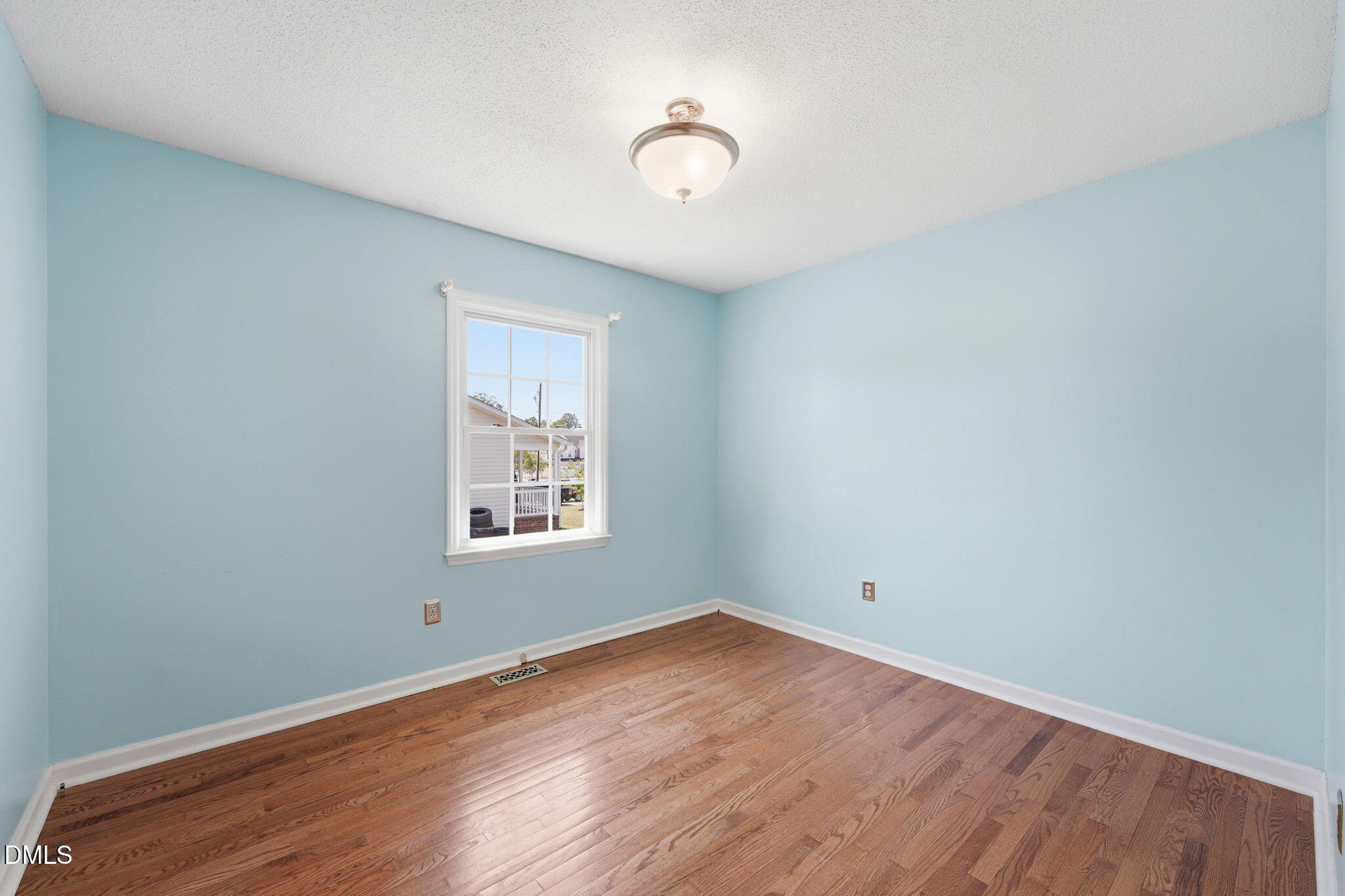 812 East Stagecoach Road Mebane, NC 27302 - Photo 13 of 25 an empty room with wooden floor and windows